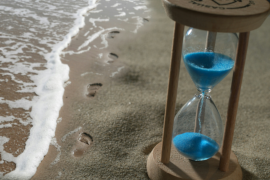 Psychic reading with hourglass, months, symbolizing why exact timing is difficult in the spirit world.